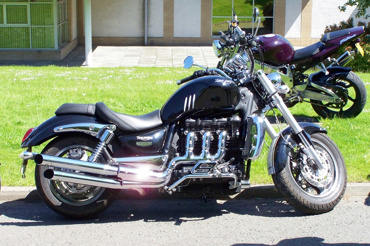 a motorcycle parked next to another parked motorcycle