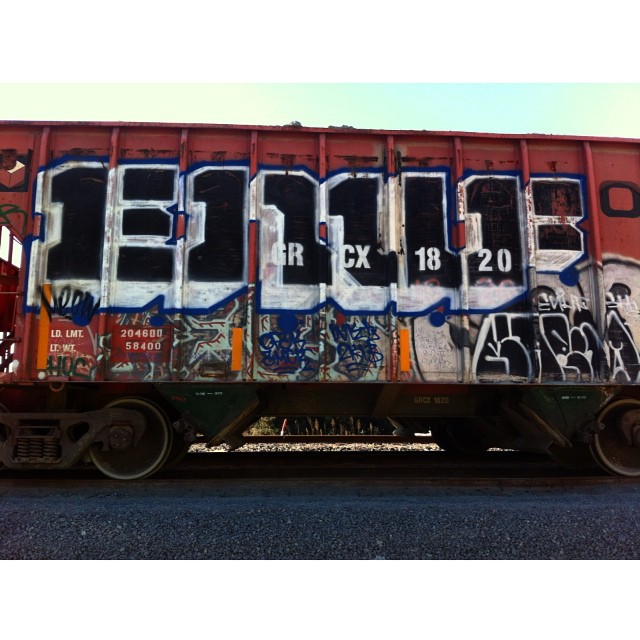 the old train has many graffiti writing on it