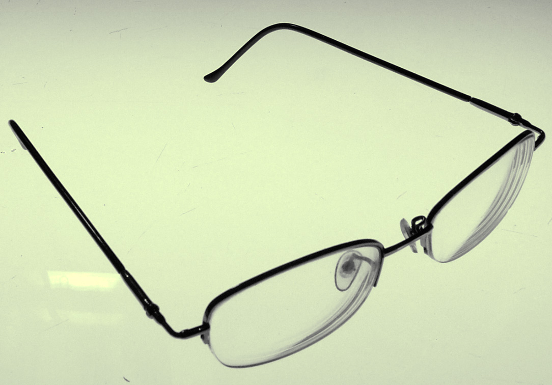 an eyeglass lying upside down on the surface