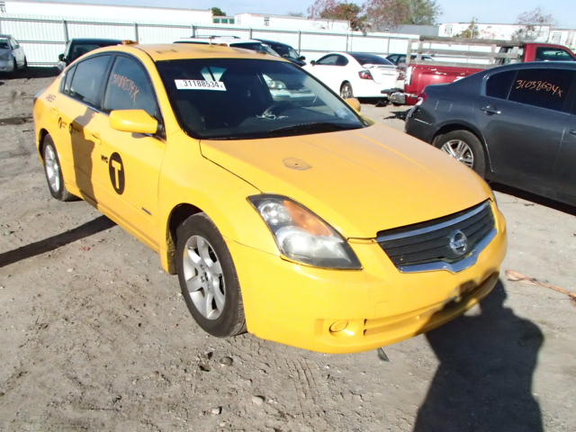 the front of a yellow taxi car that is parked in a parking lot