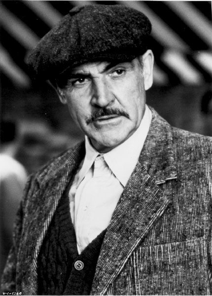 a man wearing a cap and a suit