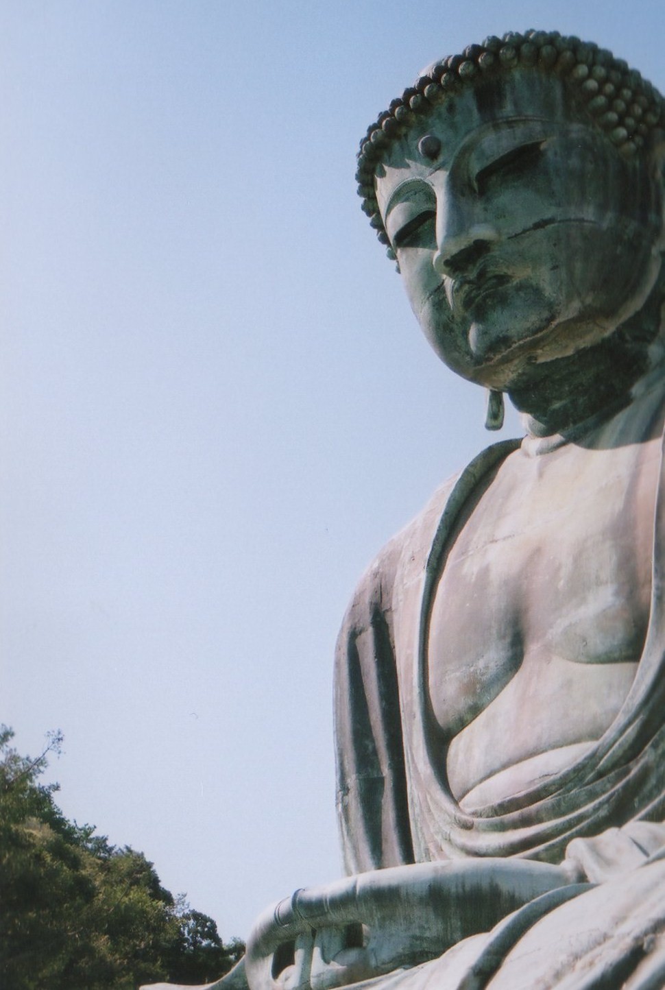 a po of the statue of buddha sits on a pedestal