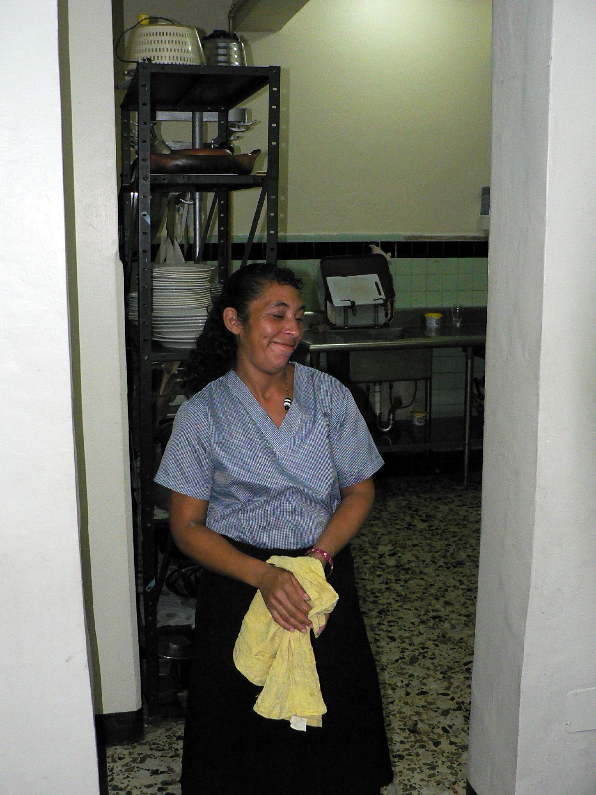 woman sitting in a kitchen with yellow dish towels
