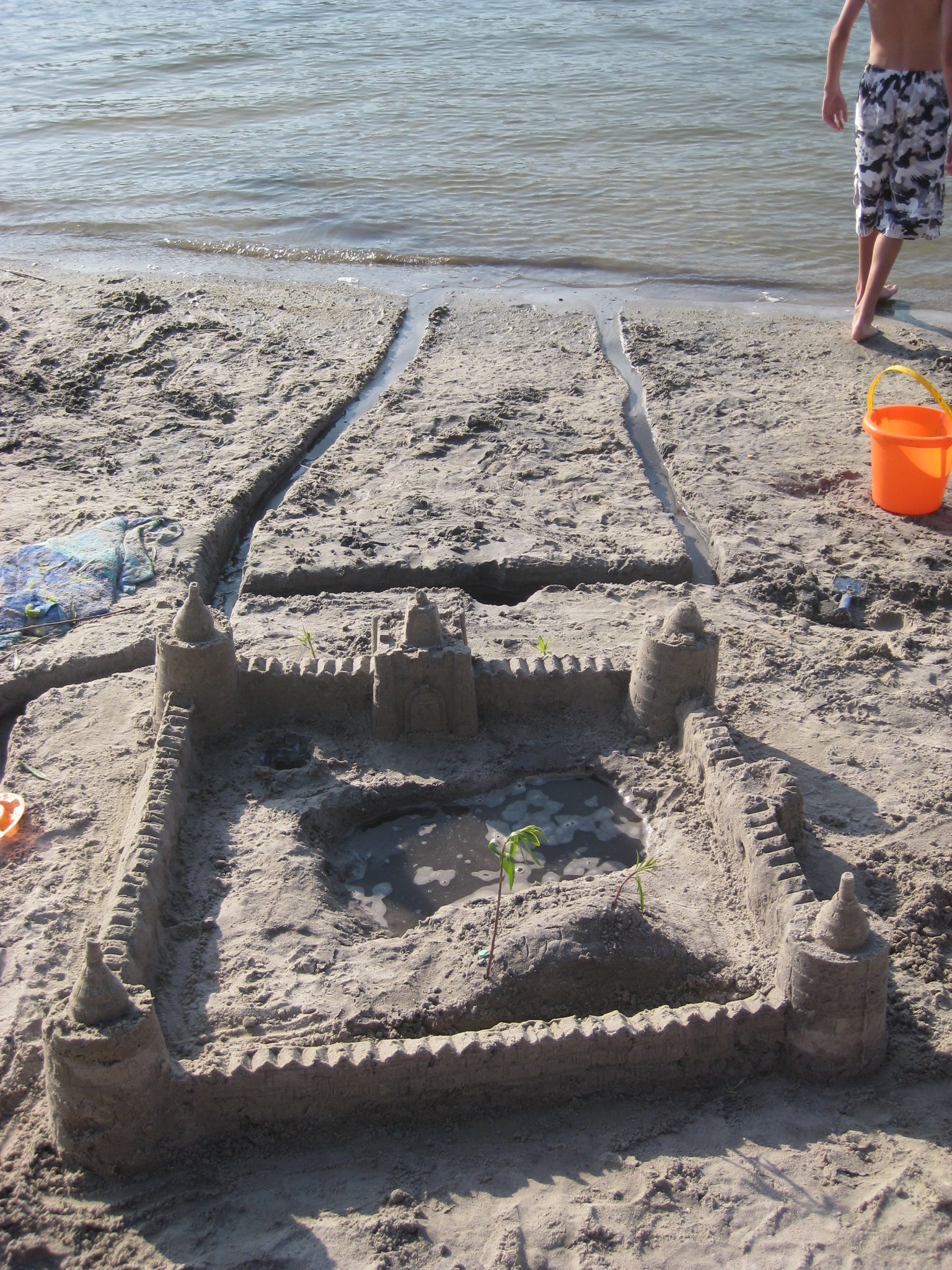 a sand castle with people in the background