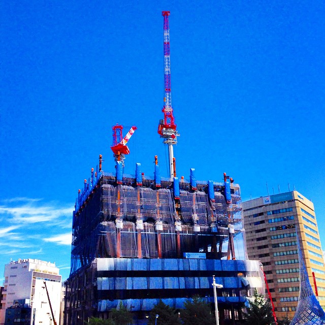 a very tall building in front of some buildings