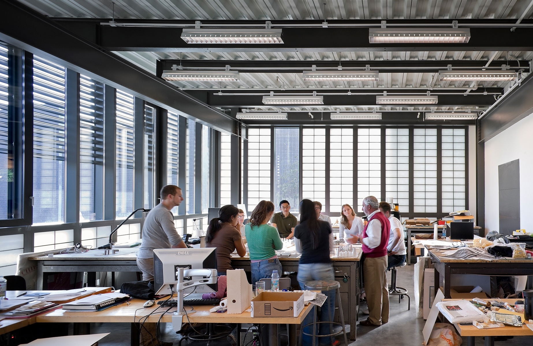 a group of people standing inside of an office