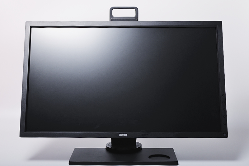 a black monitor sitting on top of a metal stand