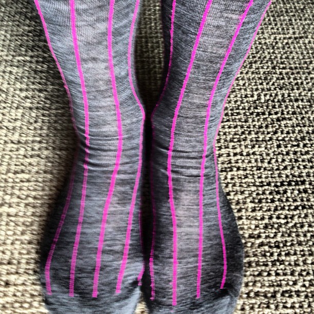 a pair of legs with pink stripes on them