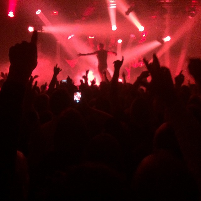 a concert with some people raising their hands