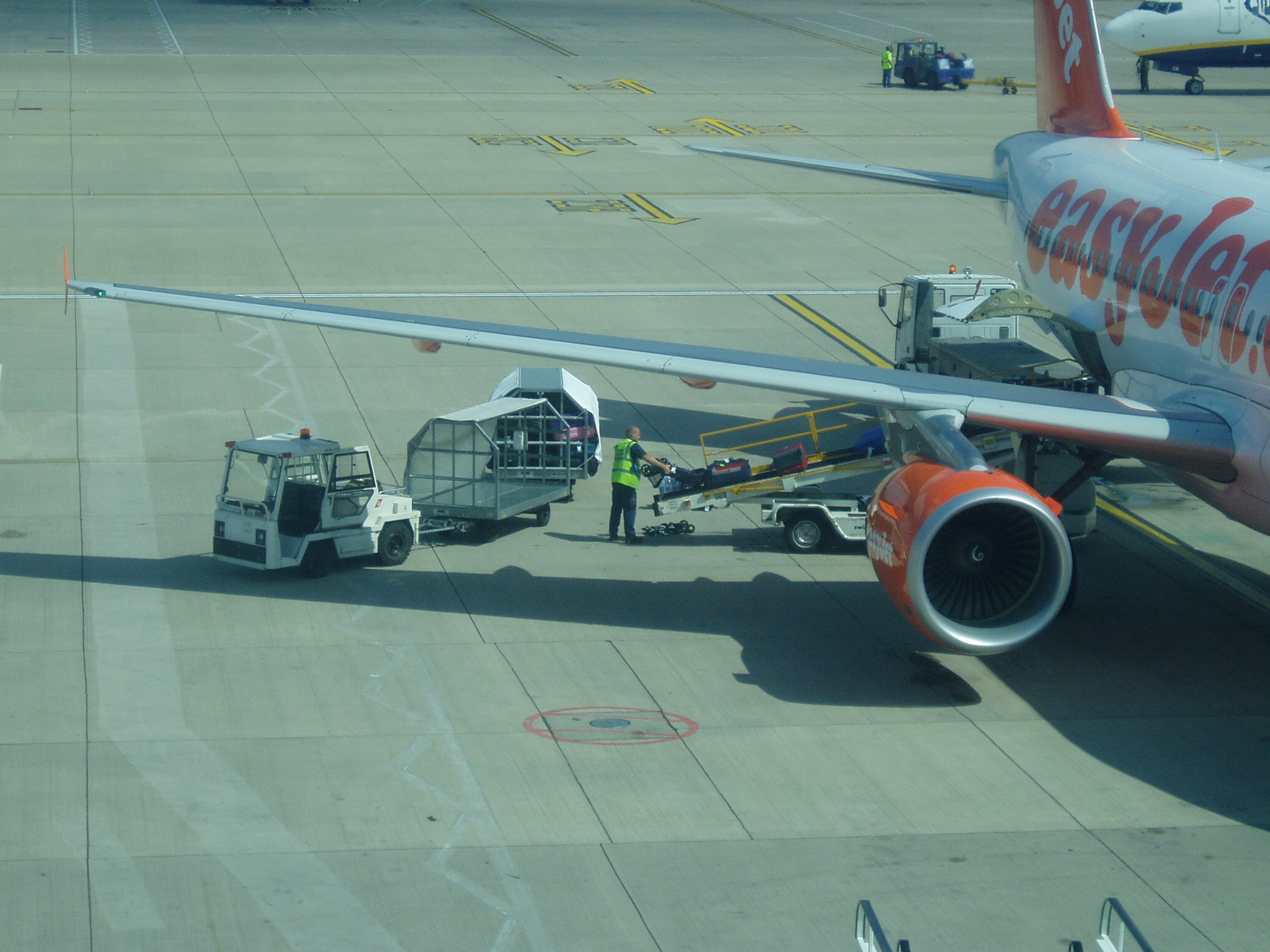 a plane parked on an airport runway while maintenance crew moves it