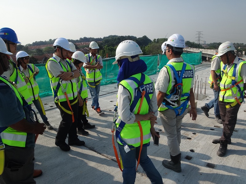 a group of construction workers standing in front of each other