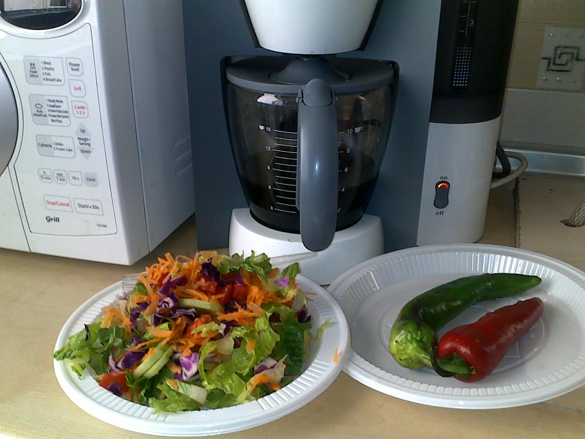 two plates filled with vegetables on a counter