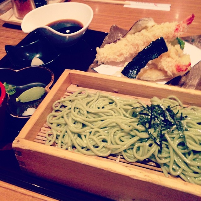 a wooden box full of noodles with various sauces