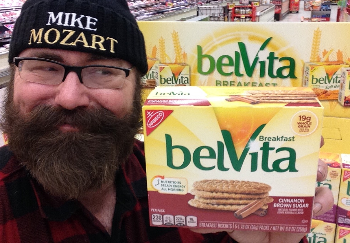 the man is holding a box of belvita in a store