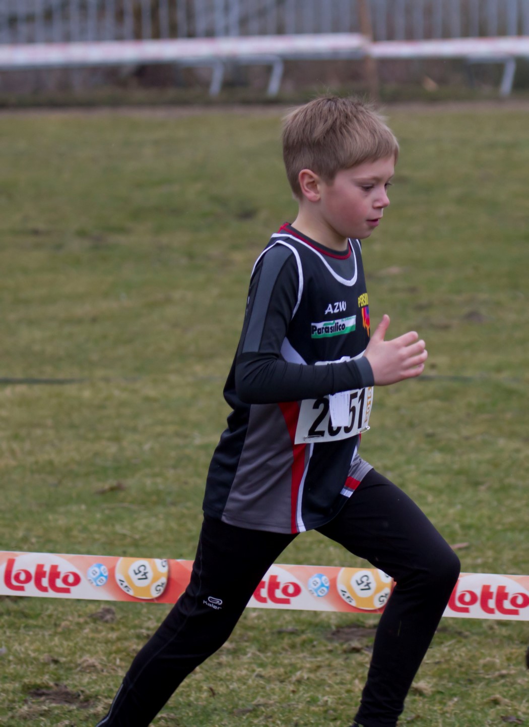  running along a grass course on a sunny day