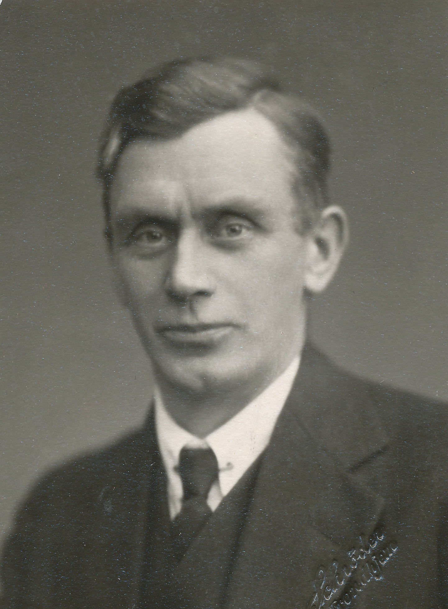 an old black and white po shows a man wearing a suit and tie