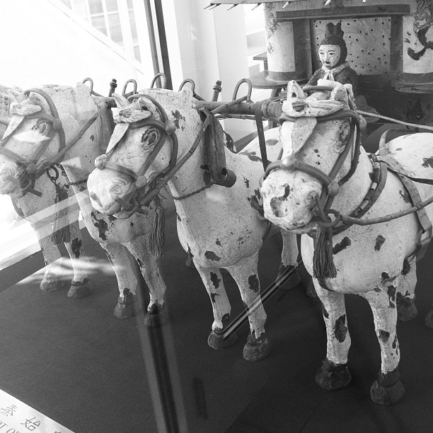 a black and white po of several toy horses