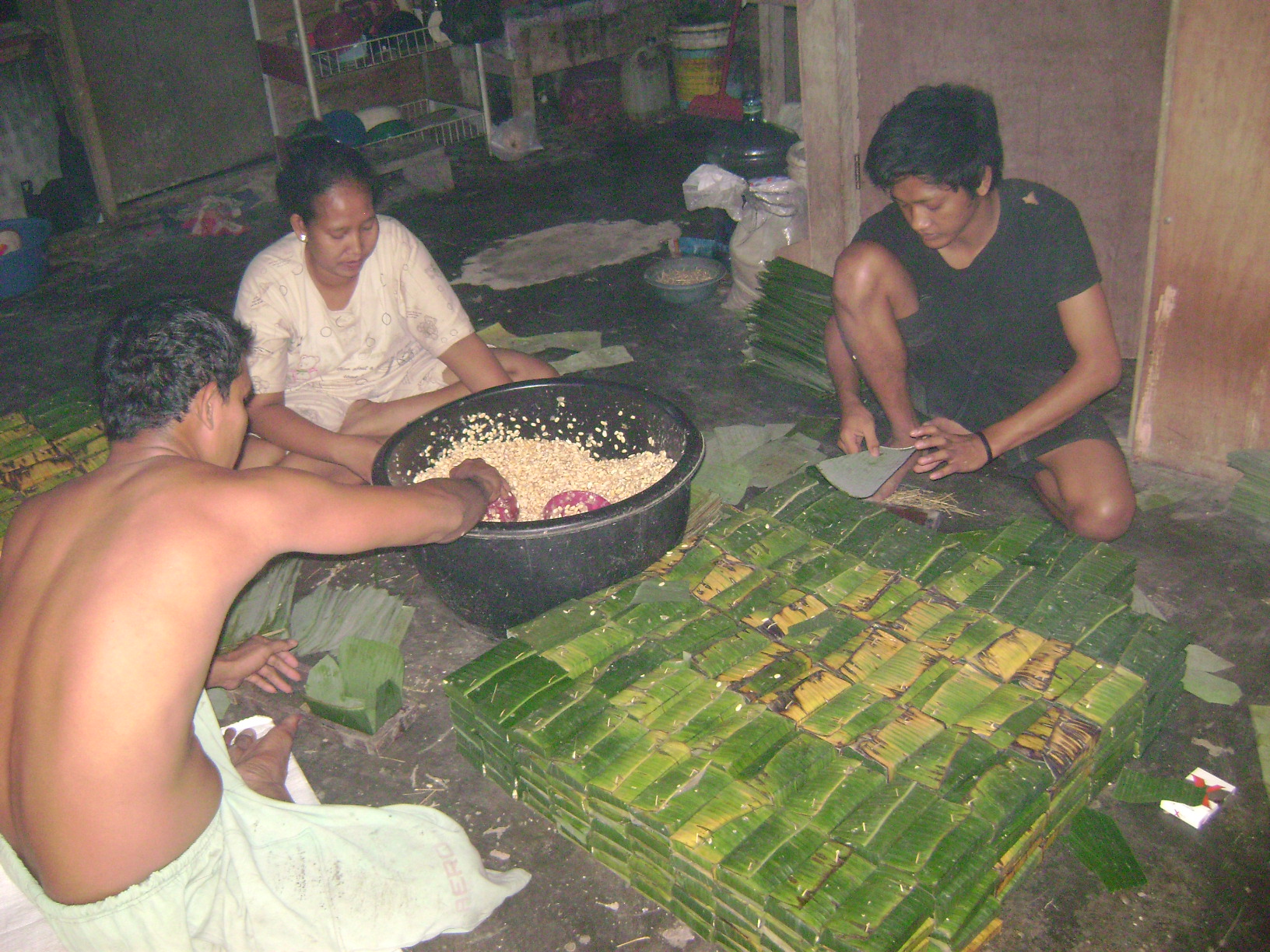people sorting rice at the side of a road