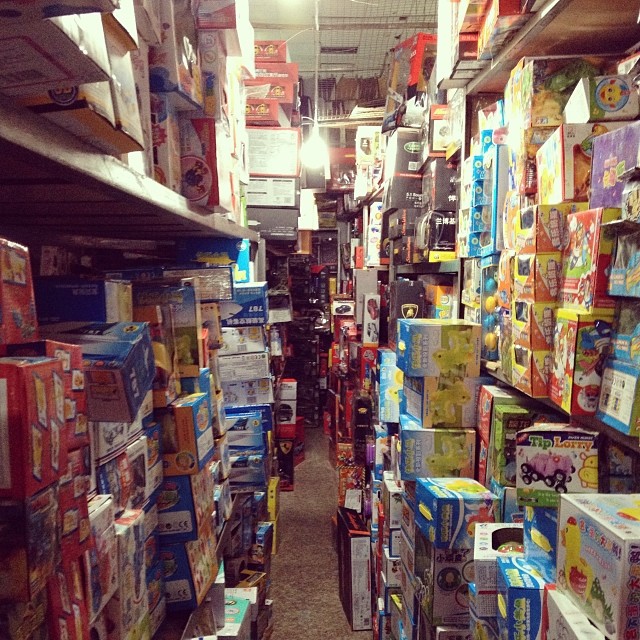 an aisle in a store full of boxes and papers