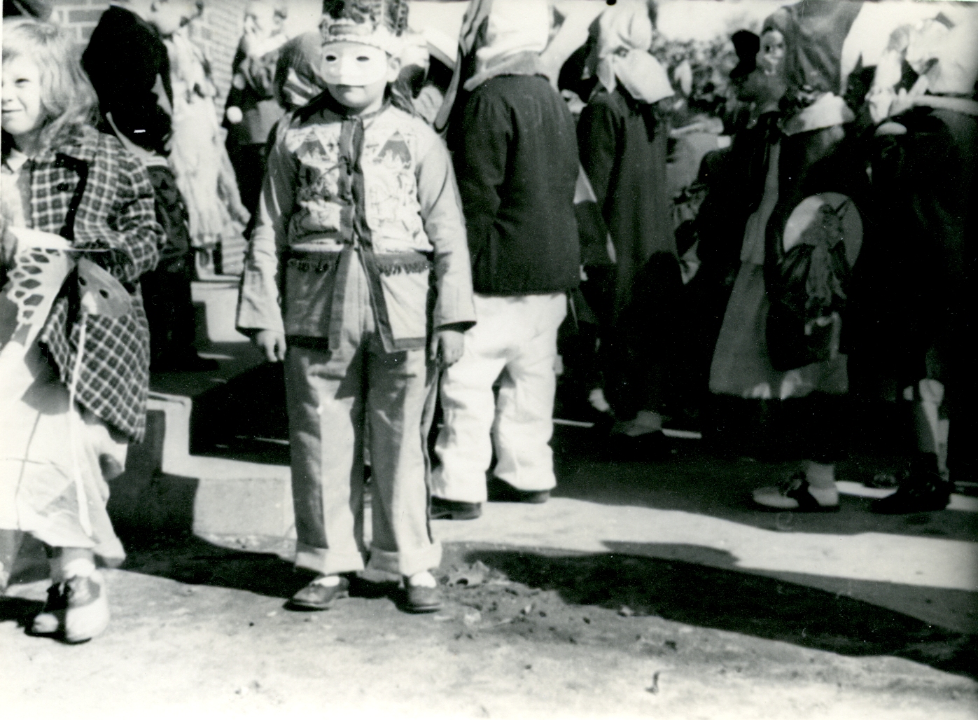 a  in costume standing next to an older man