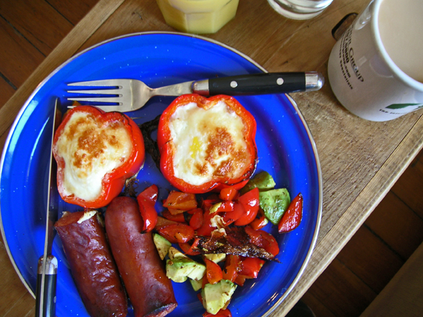 this plate has eggs, sausage, and peppers on it