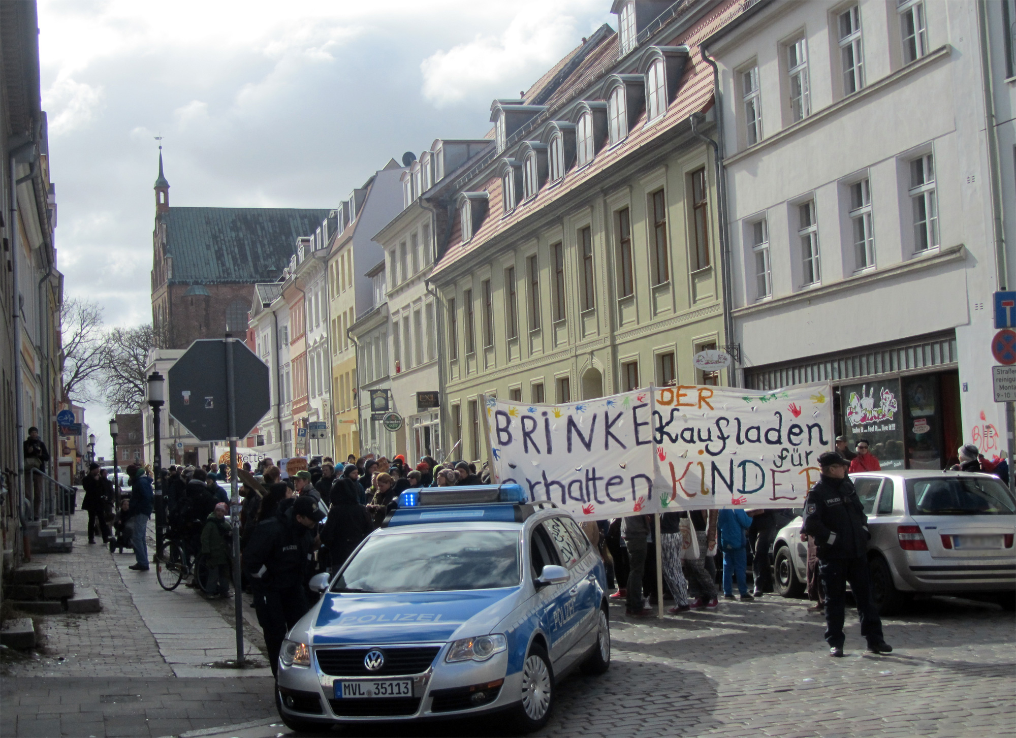 police officers stand in front of protest signs in a european town