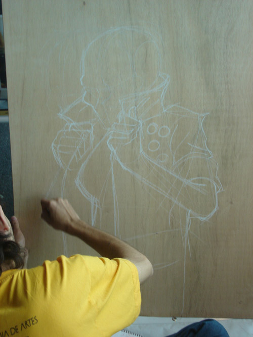 someone is drawing a character on a wooden panel