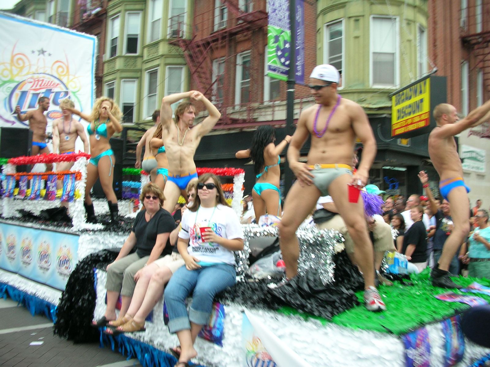 a parade float with  male and female dancers