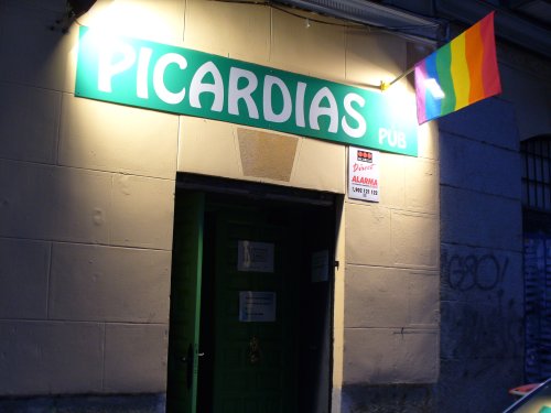 a green door sits under a sign for picards