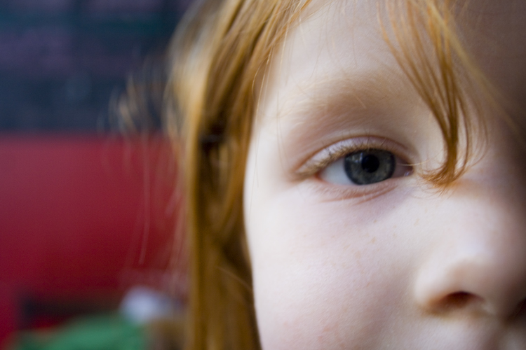 close up of a child's eye with blurry background