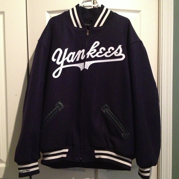 a yankees jacket hangs up on the wall