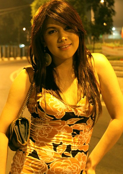 young woman standing in the street at night