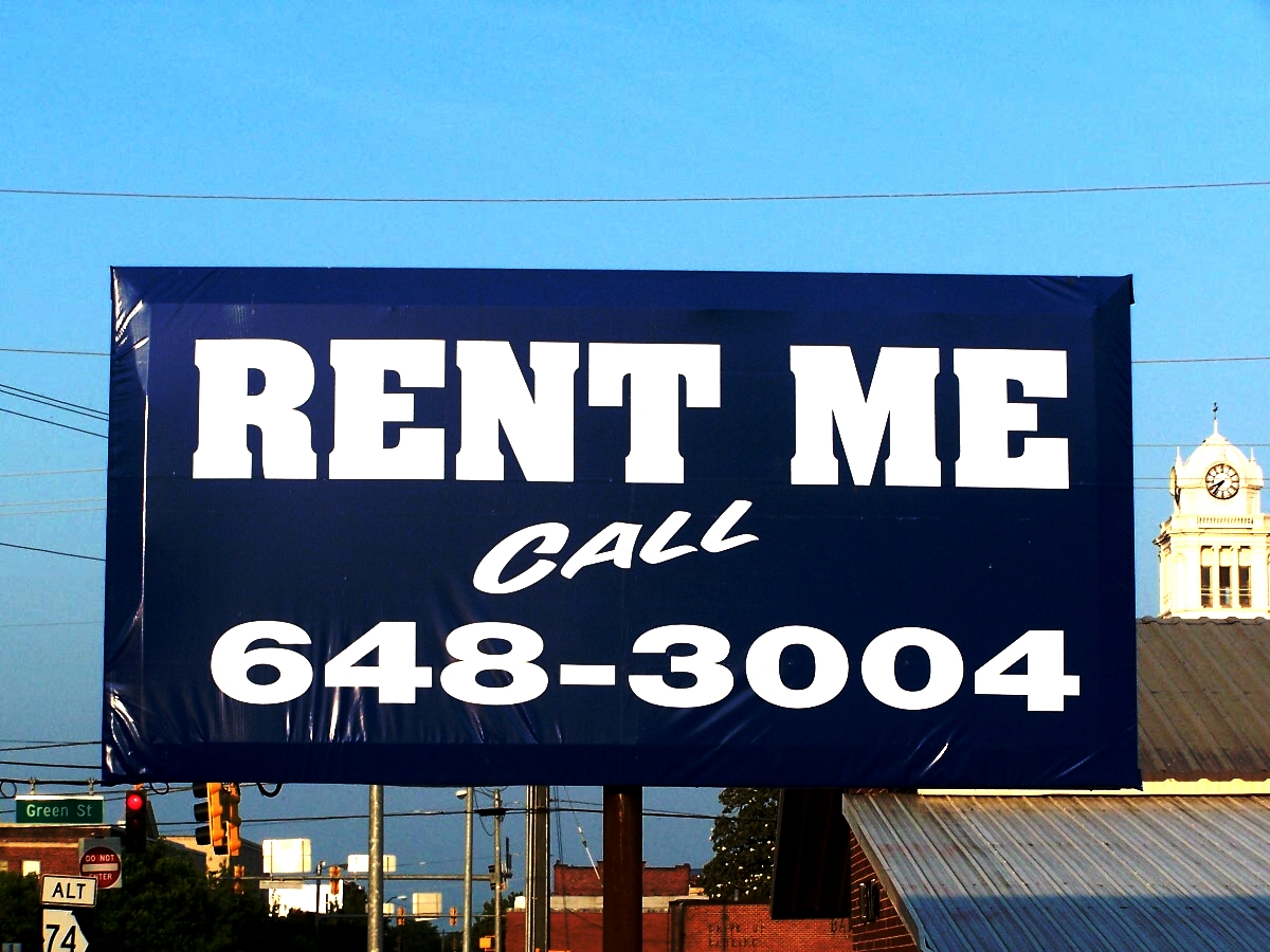 a large sign advertises a rent call