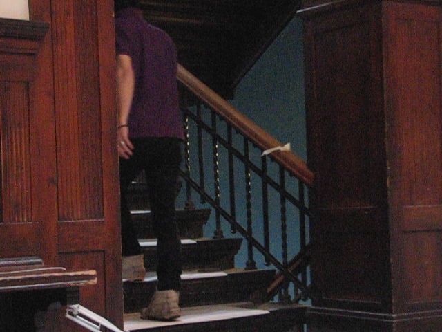 a person walking up stairs with an open door