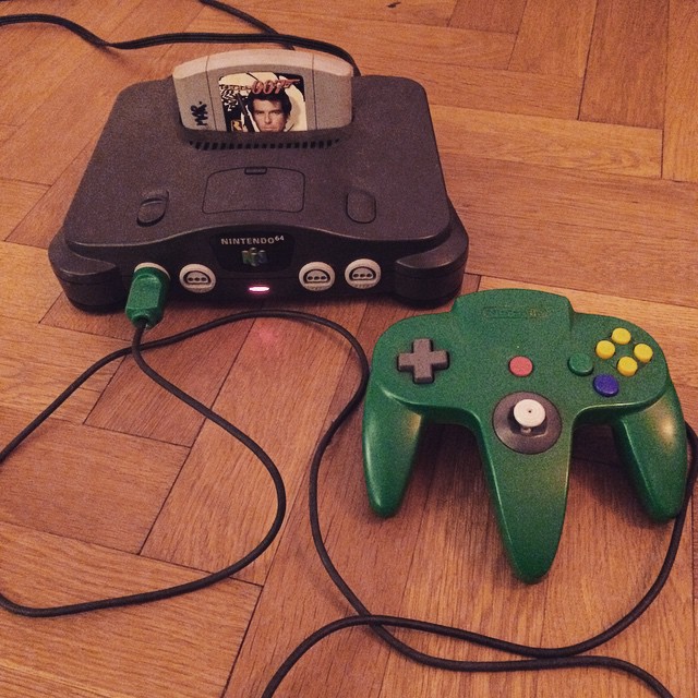 a video game controller laying on top of a wooden floor