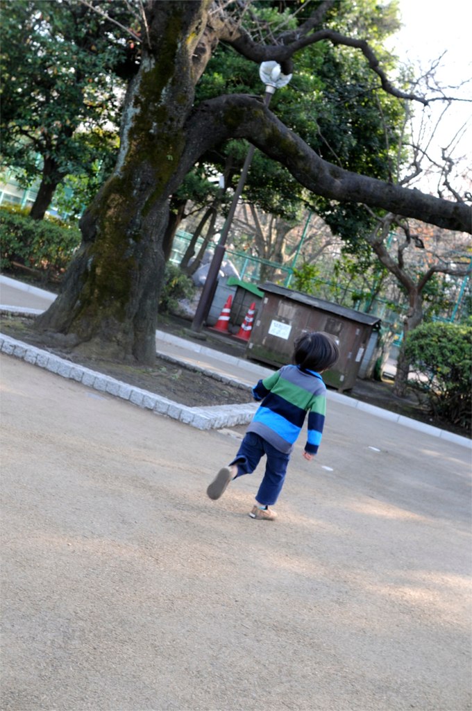 a boy running and throwing a soccer ball into the air