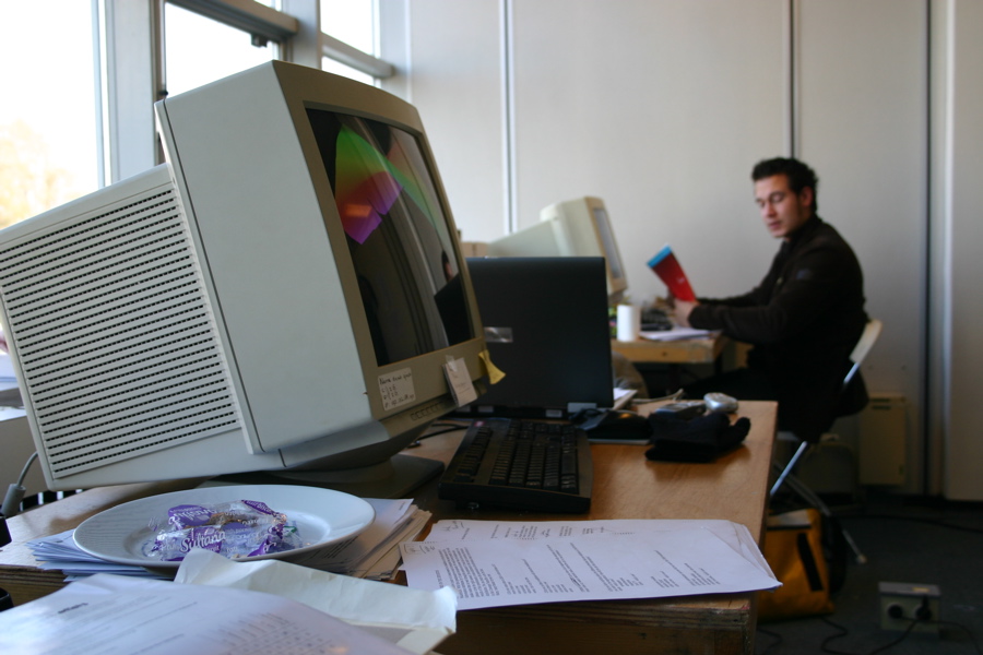 a person sitting at a desk with paper on it