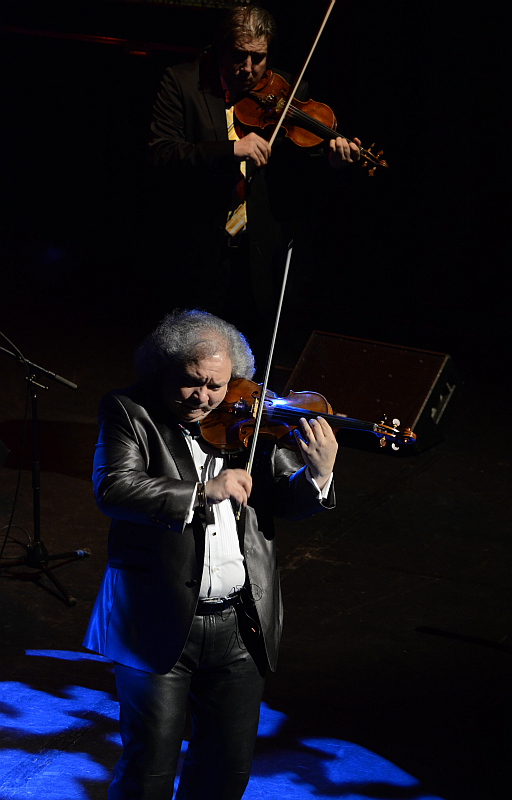 a man holding a violin and a violin