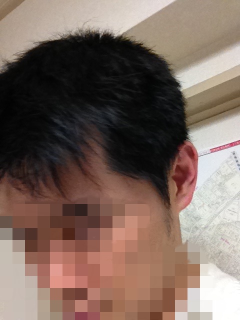 an asian male with very short black hair