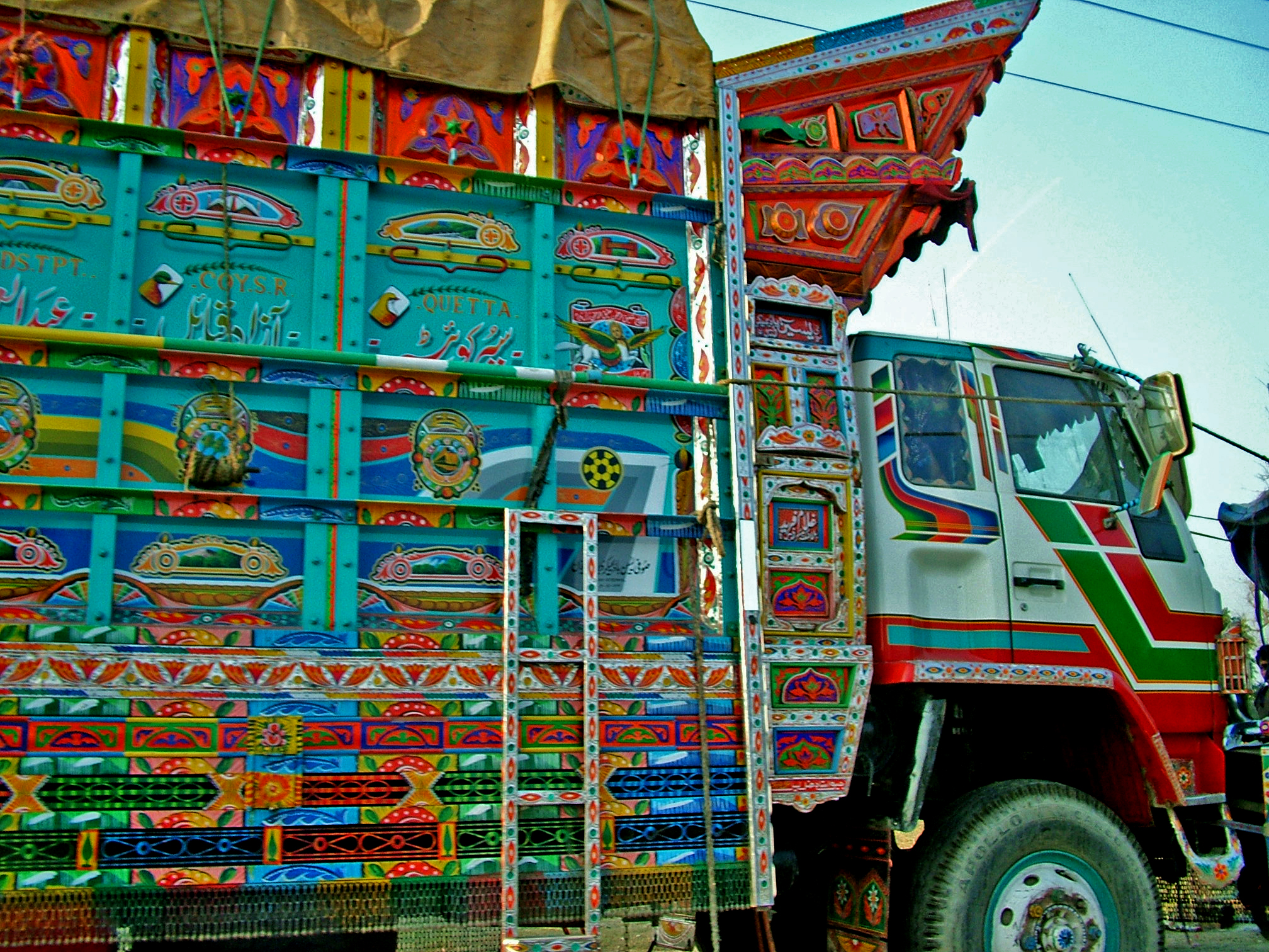 a multi colored truck sitting on top of a road