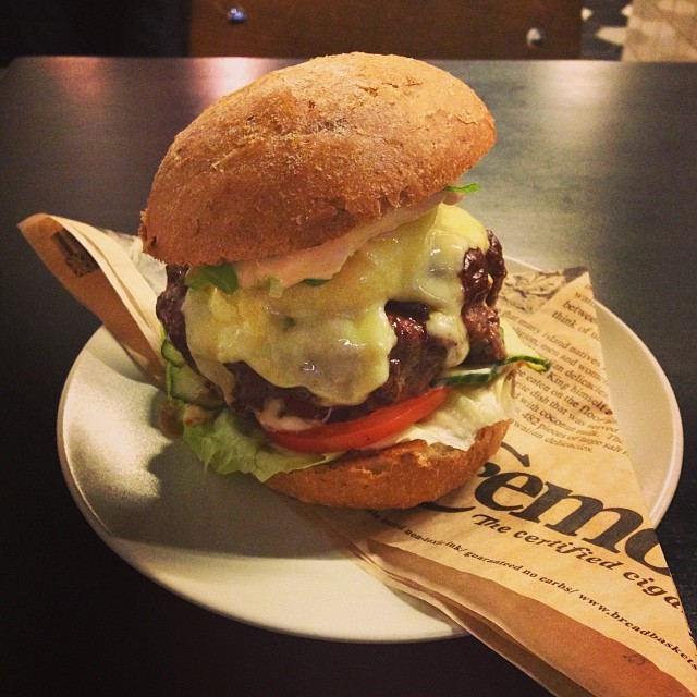 sandwich on plate on table at dining establishment