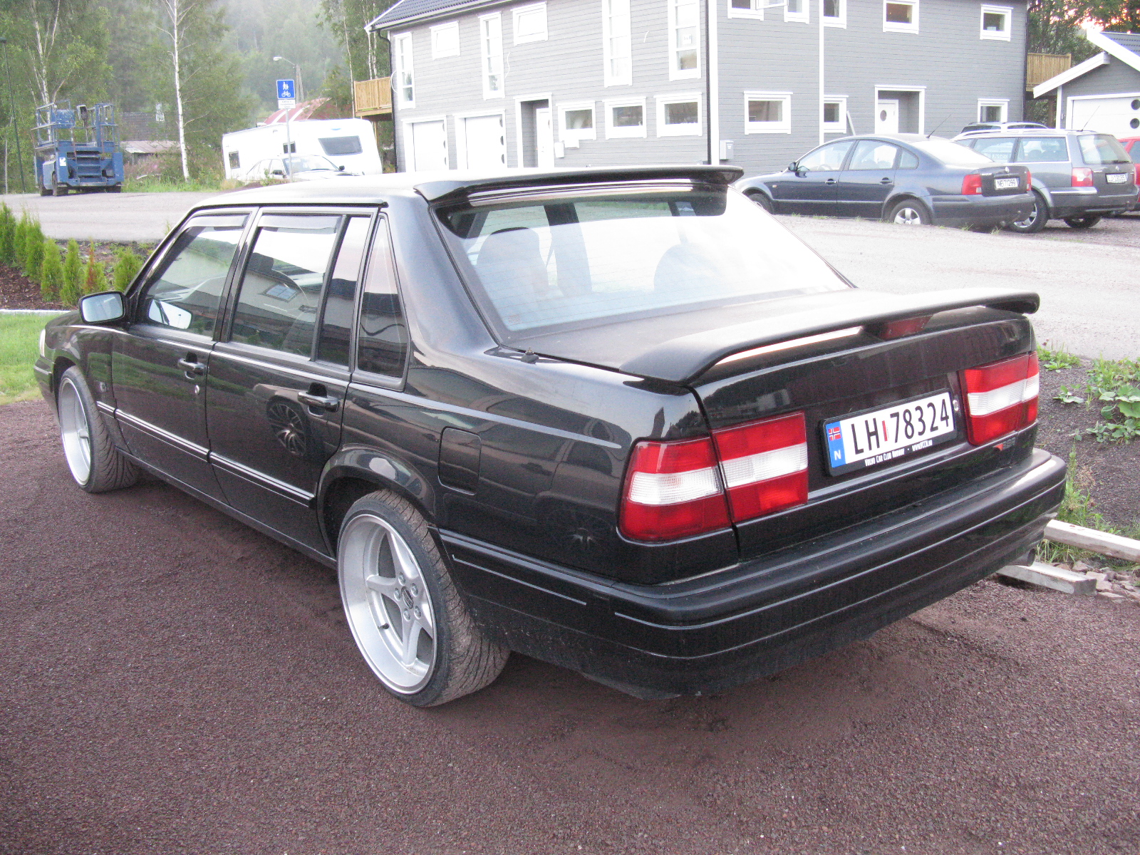 a black mercedes is parked in the street