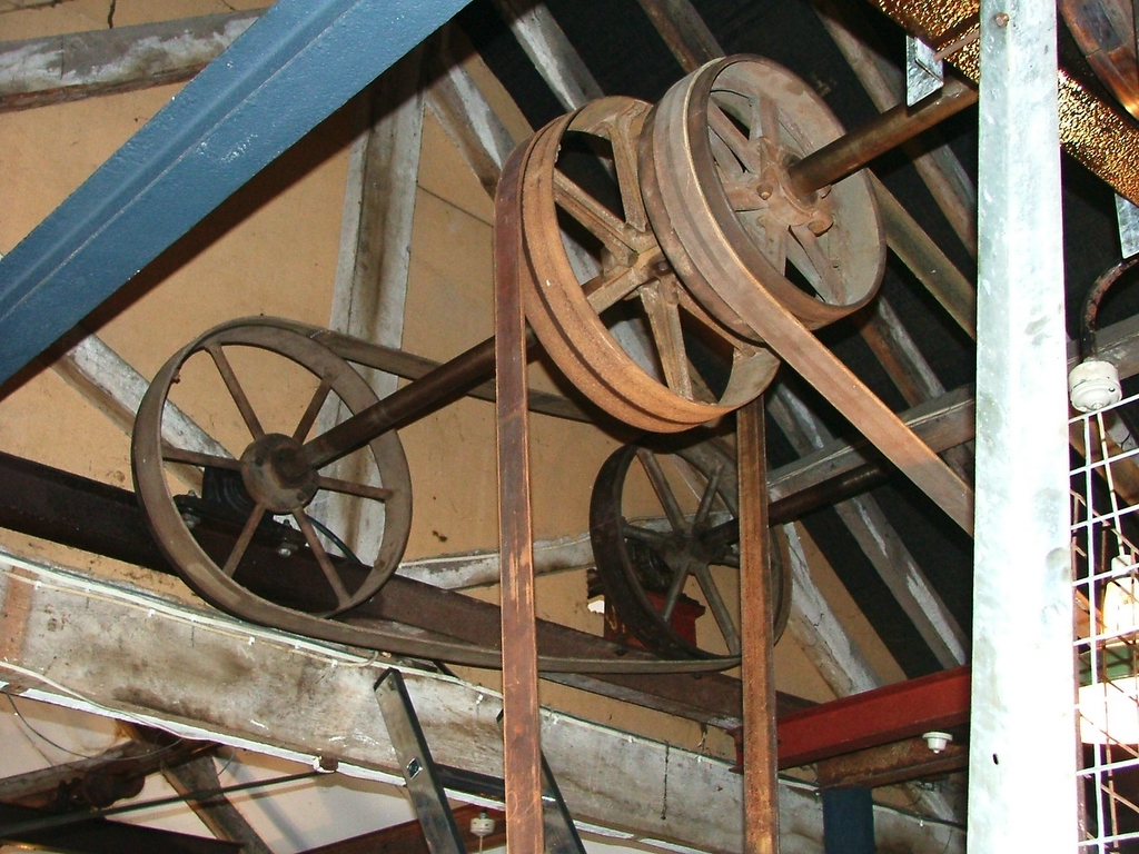 a spinning wheel hanging from the ceiling of a building