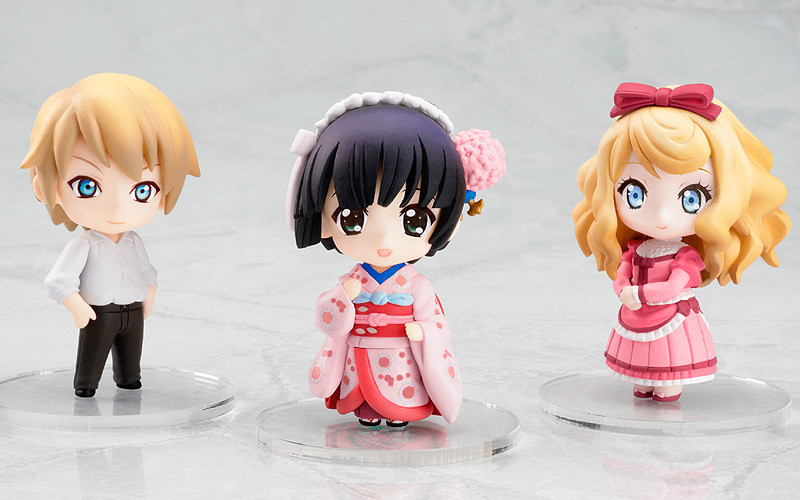 three anime figurines standing on a white surface