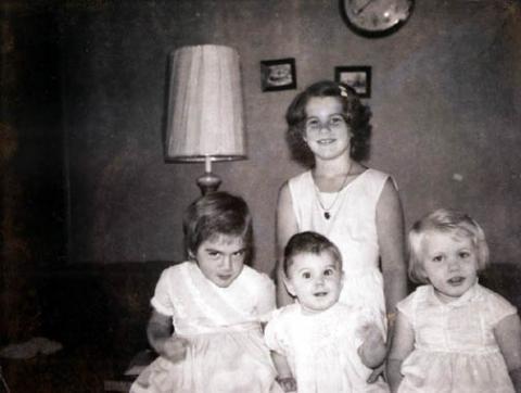 a black and white po of a mother with her three daughters
