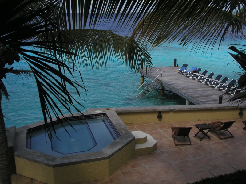 a view of an outdoor  tub with a dock and chairs