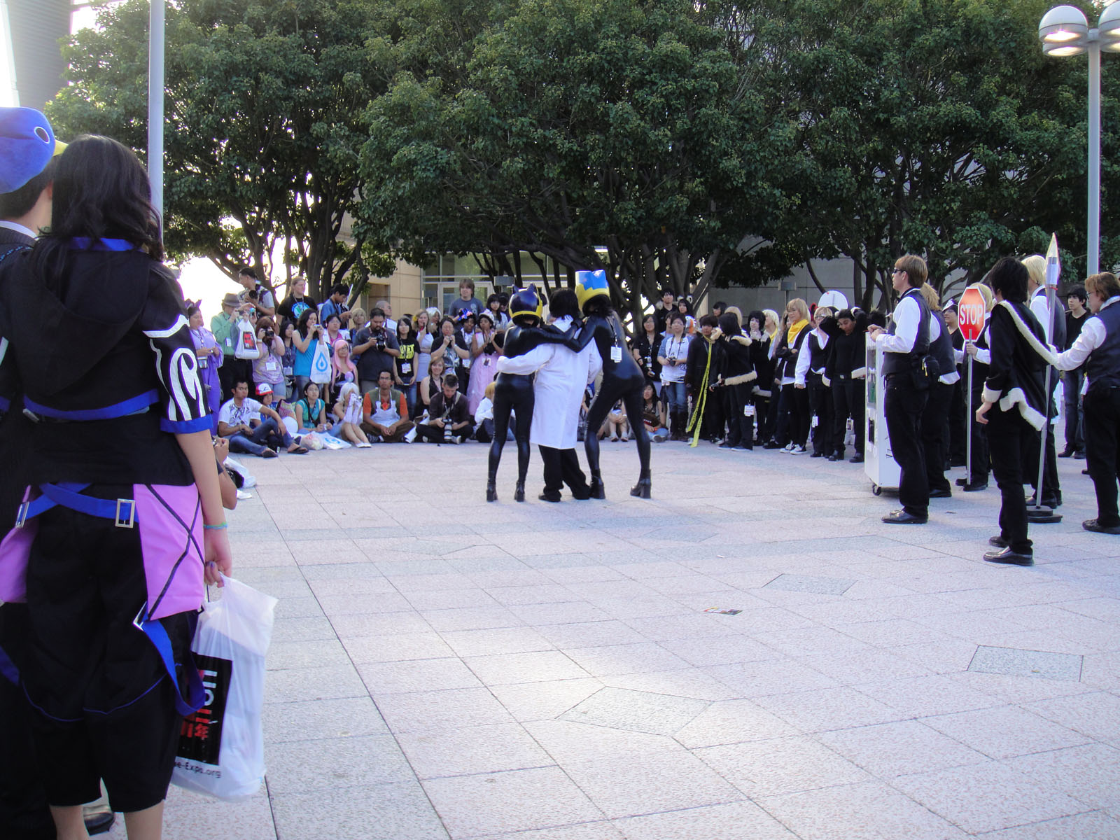 many people in costumes are standing outside