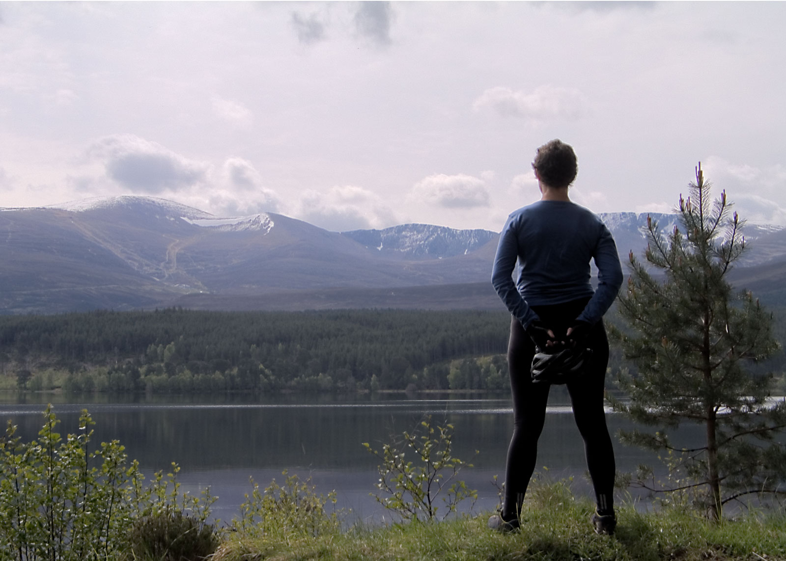 man on top of hill gazing at the scenery