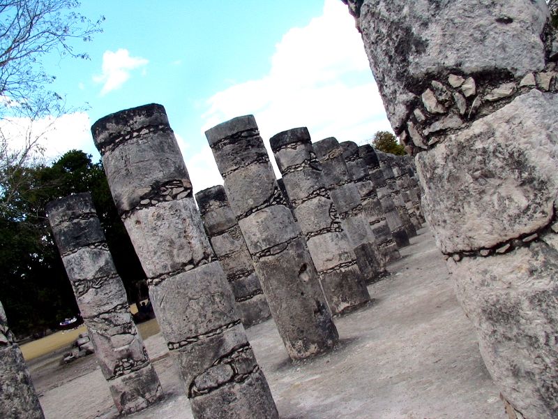 ancient rock formations stand in rows near a path