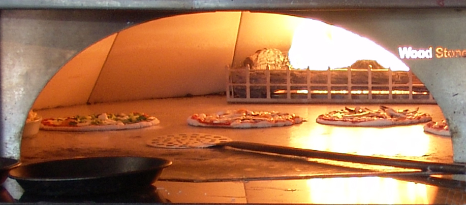 pizzas are being cooked inside an oven